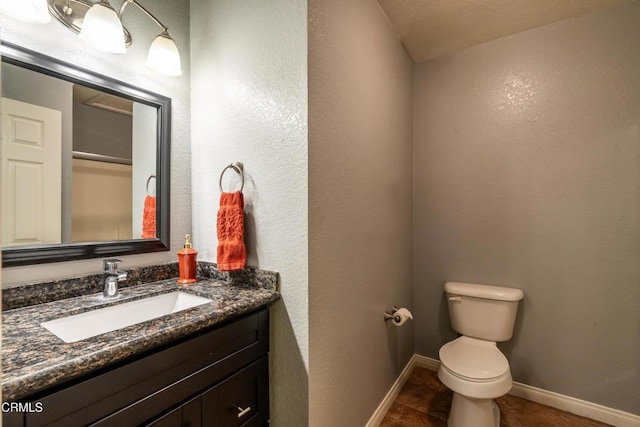 bathroom featuring tile patterned flooring, vanity, and toilet