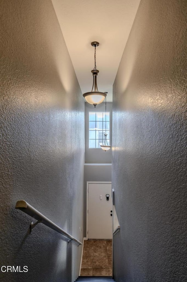 stairs featuring tile patterned flooring