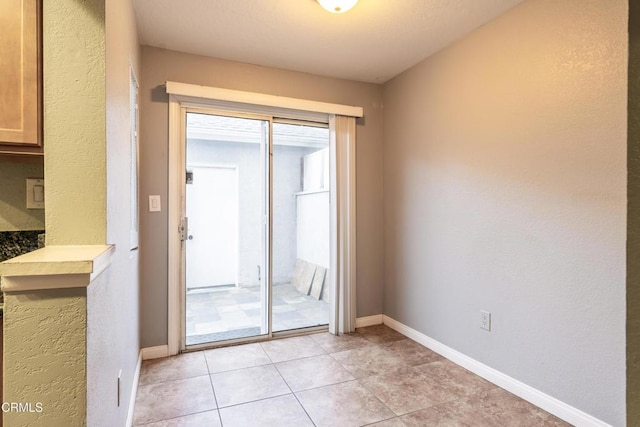 doorway featuring light tile patterned flooring