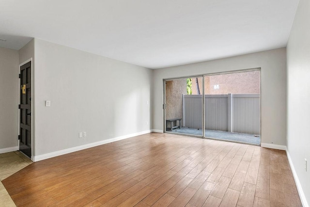 spare room with hardwood / wood-style floors