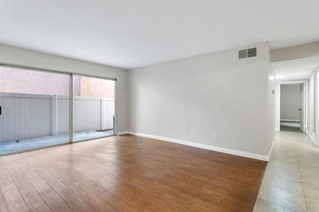 unfurnished room featuring hardwood / wood-style flooring