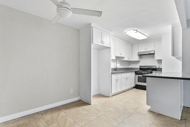 kitchen with decorative backsplash, stainless steel gas range, ceiling fan, sink, and white cabinets