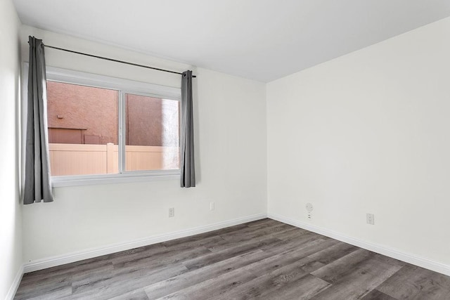 unfurnished room with hardwood / wood-style flooring