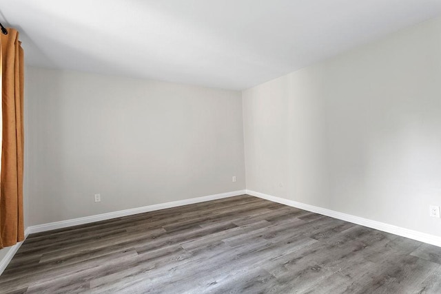 spare room with hardwood / wood-style floors