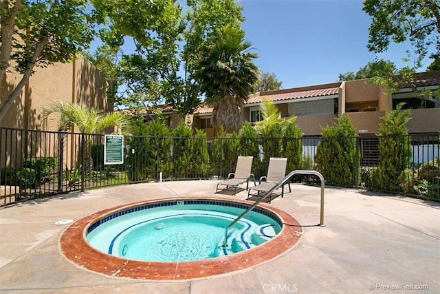 view of pool featuring a patio area and a hot tub