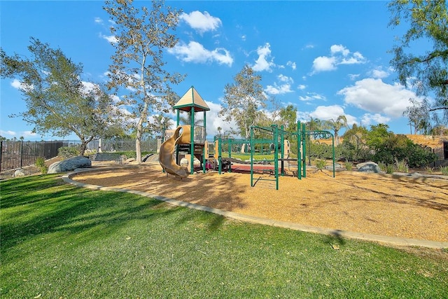 communal playground with a yard and fence