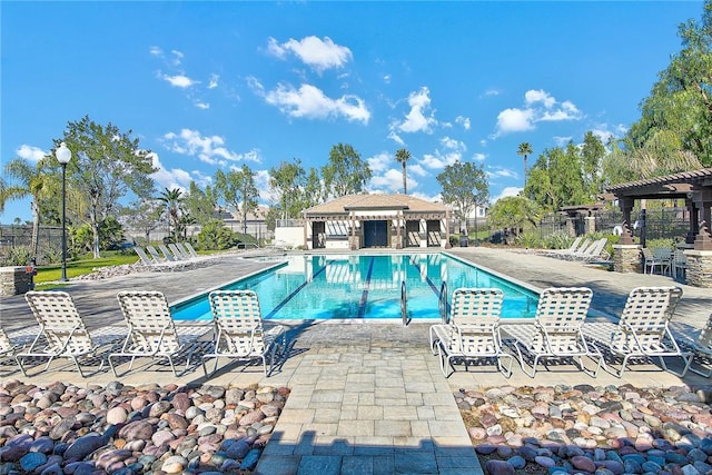 pool featuring a patio area, a pergola, and fence