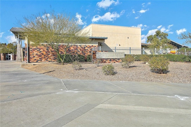 view of home's exterior featuring fence and stucco siding