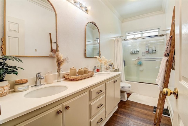 full bathroom featuring toilet, shower / bath combination with glass door, ornamental molding, vanity, and hardwood / wood-style floors