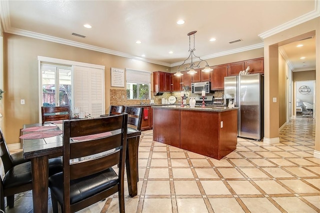 kitchen with stainless steel appliances, a center island, backsplash, and decorative light fixtures