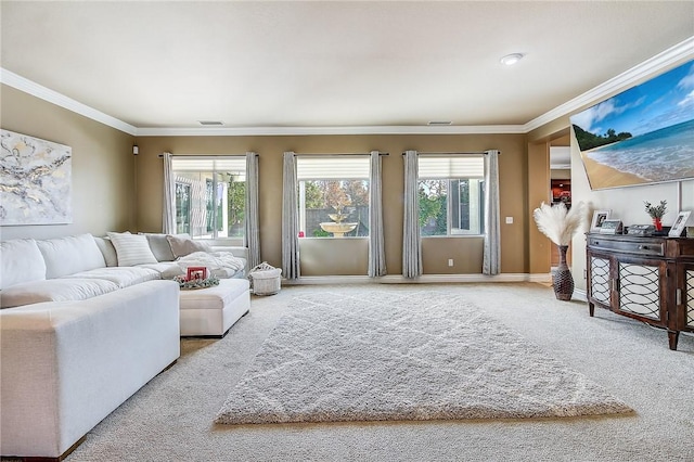 living room featuring carpet flooring, a healthy amount of sunlight, and ornamental molding