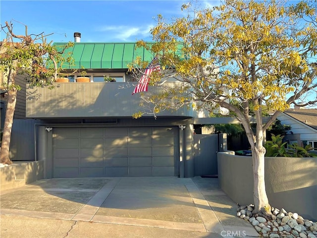 253 Fairview St, Laguna Beach, CA 92651 - view of front of home featuring metal roof, fence, a garage, a standing seam roof, and driveway