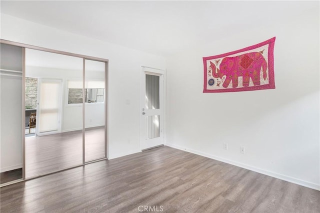 253 Fairview St, Laguna Beach, CA 92651 - unfurnished bedroom featuring a closet, baseboards, and wood finished floors