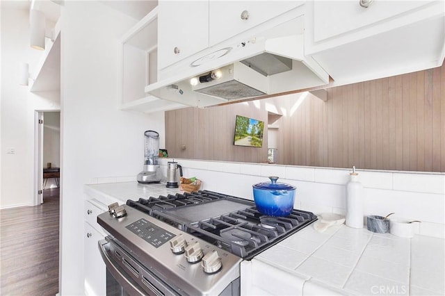 253 Fairview St, Laguna Beach, CA 92651 - kitchen with tile counters, white cabinetry, tasteful backsplash, under cabinet range hood, and gas stove