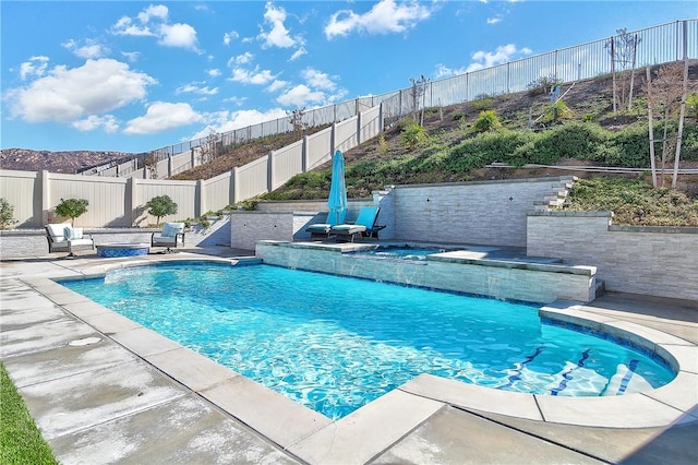 view of swimming pool with a mountain view and a patio