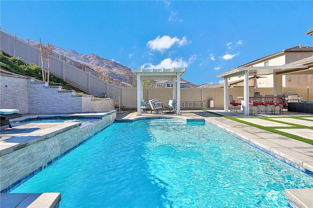 view of pool with an in ground hot tub, a pergola, a bar, a mountain view, and a patio