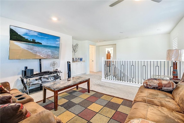 carpeted living room with ceiling fan