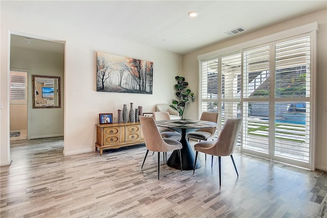 dining space with light hardwood / wood-style floors