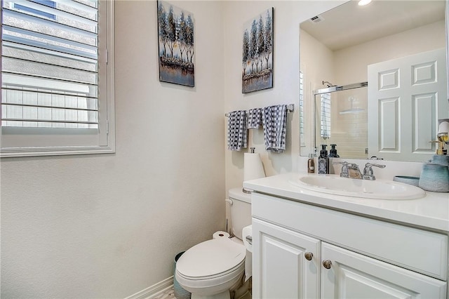 bathroom featuring vanity, toilet, and an enclosed shower