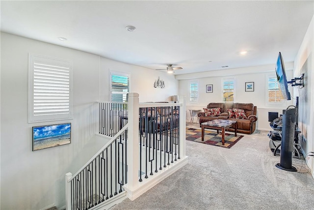 carpeted living room featuring plenty of natural light and ceiling fan