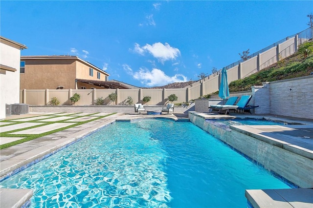 view of swimming pool featuring a patio area and cooling unit