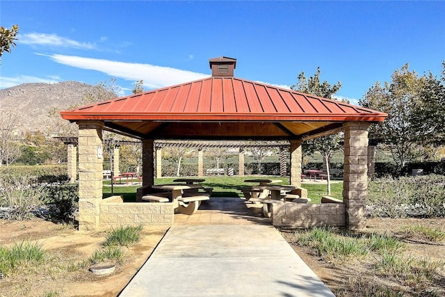 surrounding community featuring a gazebo and a mountain view