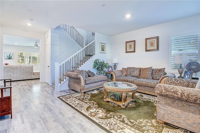 living room with ceiling fan and hardwood / wood-style flooring