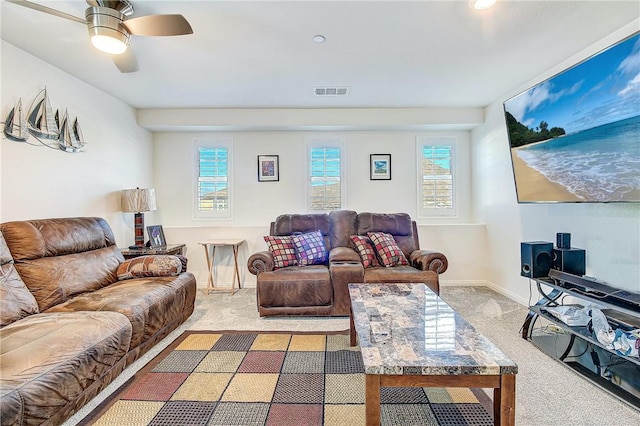 living room featuring carpet flooring, ceiling fan, and a healthy amount of sunlight