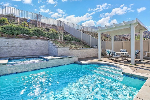 view of swimming pool with an in ground hot tub and a patio