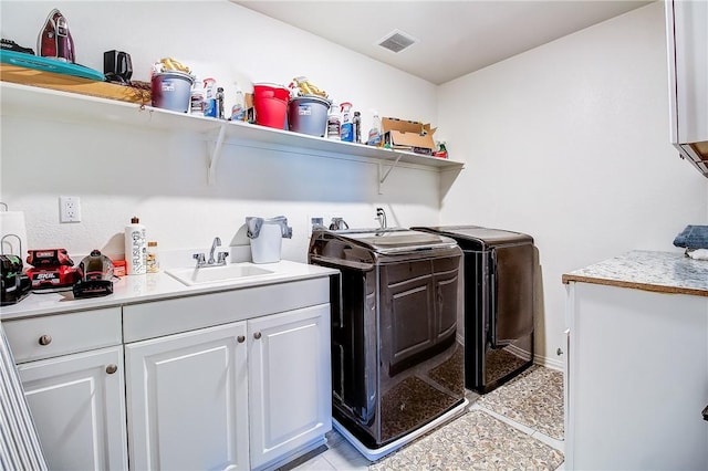 laundry room featuring washer and dryer, light tile patterned flooring, cabinets, and sink