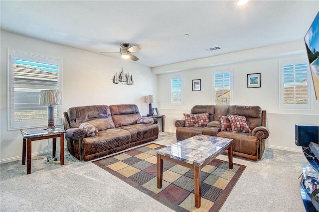 carpeted living room with ceiling fan