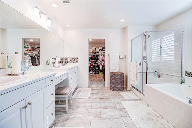 bathroom with separate shower and tub and vanity