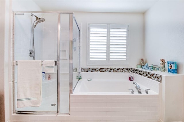 bathroom featuring independent shower and bath