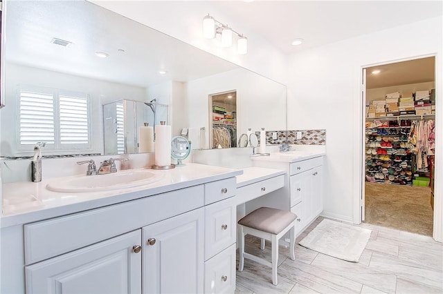 bathroom with vanity and an enclosed shower