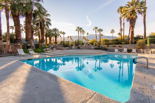 view of swimming pool featuring a mountain view and a patio area