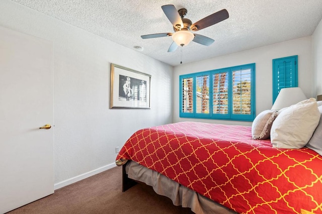 carpeted bedroom featuring ceiling fan and a textured ceiling