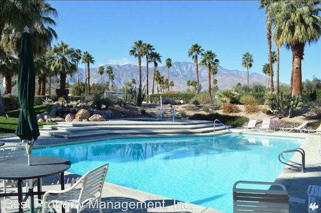 view of pool featuring a mountain view and a patio area