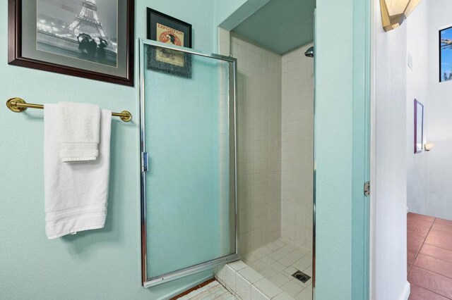 bathroom with tile patterned floors and an enclosed shower