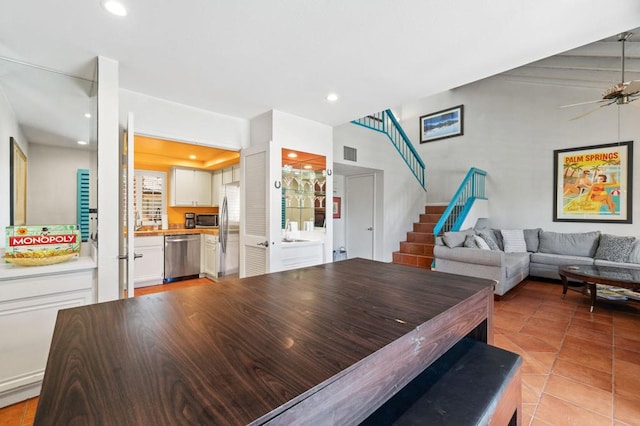 tiled living room with ceiling fan