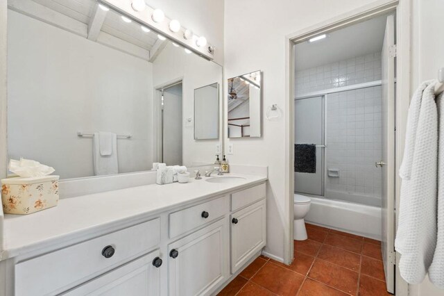 full bathroom with tile patterned floors, vanity, toilet, and enclosed tub / shower combo