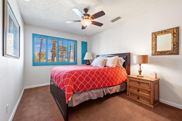 bedroom with carpet flooring, ceiling fan, and a textured ceiling