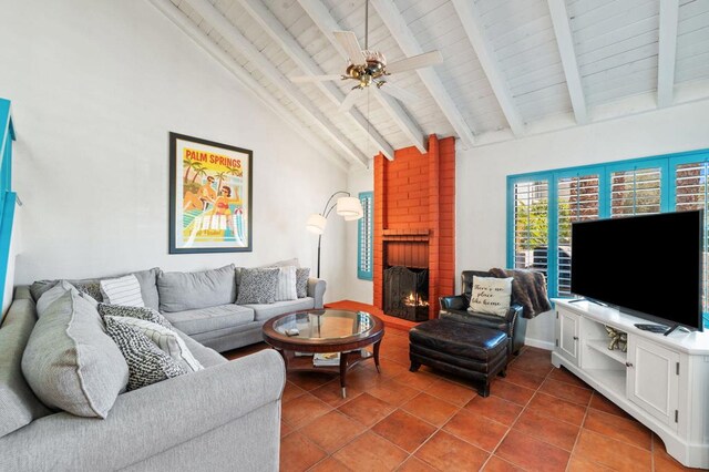 tiled living room featuring a fireplace, high vaulted ceiling, ceiling fan, and beamed ceiling