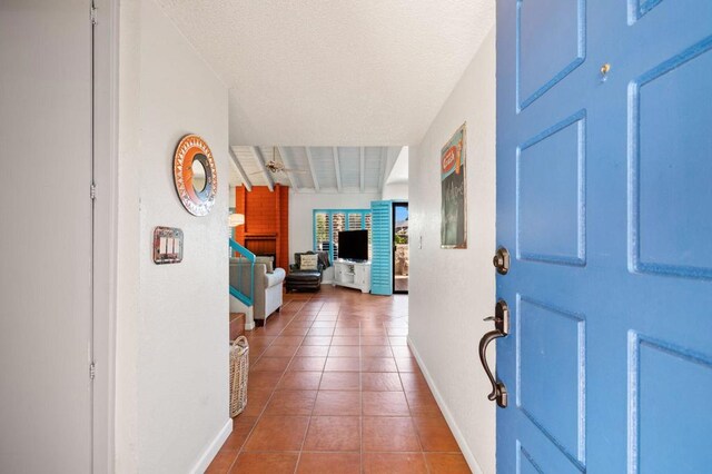 tiled foyer featuring a textured ceiling