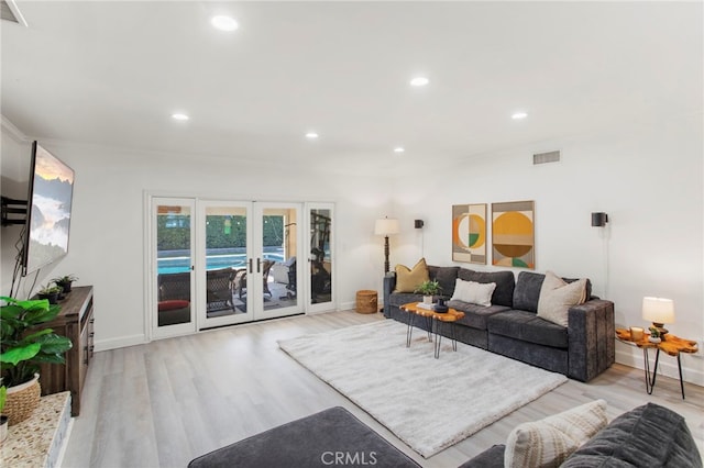 living room with french doors and light hardwood / wood-style flooring