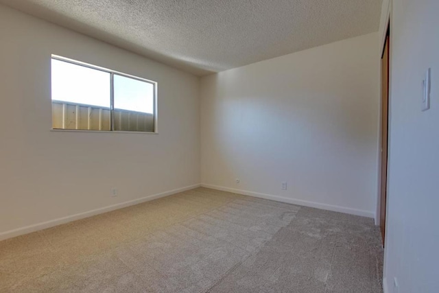 spare room with carpet floors and a textured ceiling