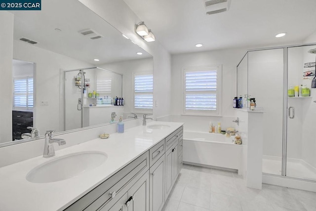 bathroom with a healthy amount of sunlight, tile patterned floors, vanity, and plus walk in shower