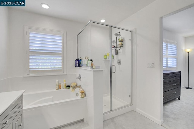 bathroom with separate shower and tub and vanity