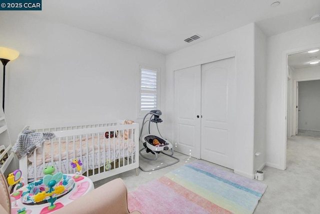 bedroom with light colored carpet and a crib