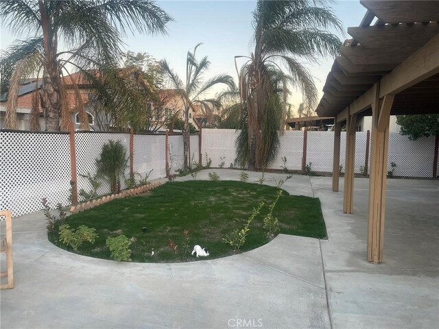 yard at dusk with a patio