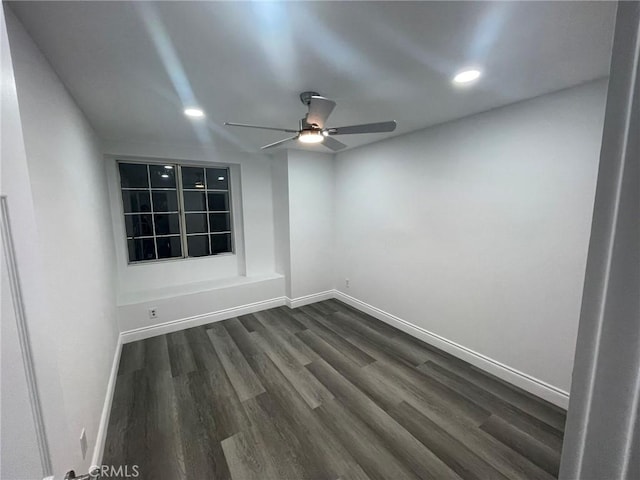 empty room with ceiling fan and dark hardwood / wood-style floors